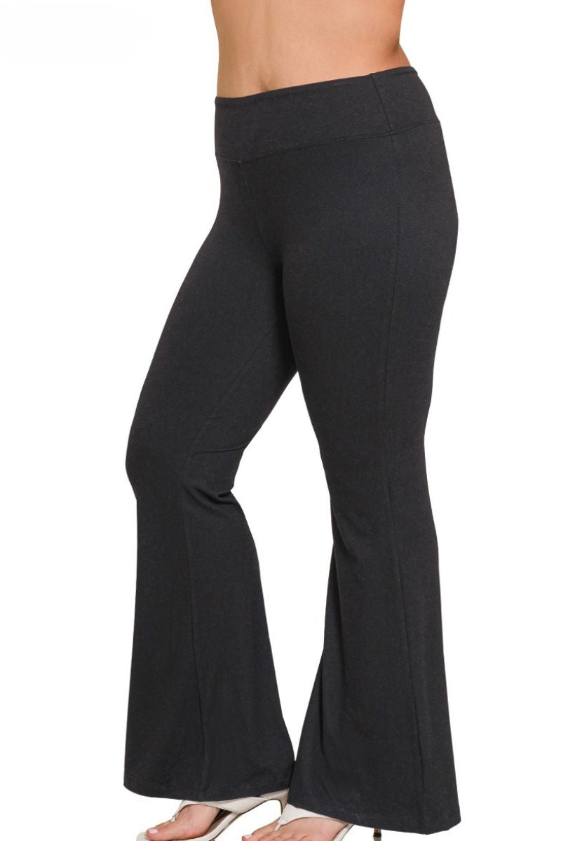 Black flared pants worn by a person on a white background