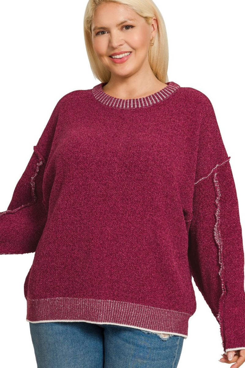 Woman wearing a maroon sweater with white trim on a white background