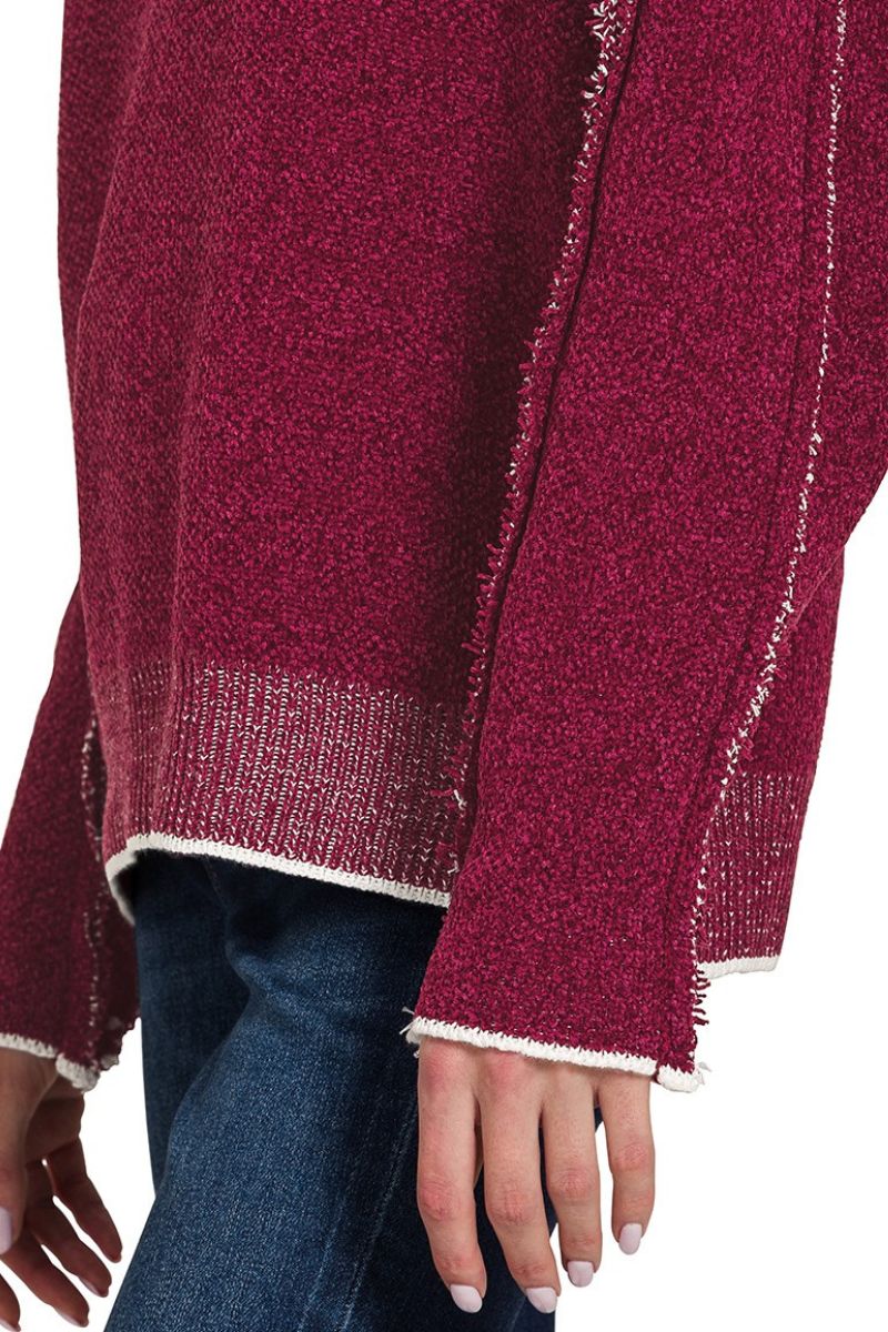 Close-up of a maroon sweater with white trim on a white background