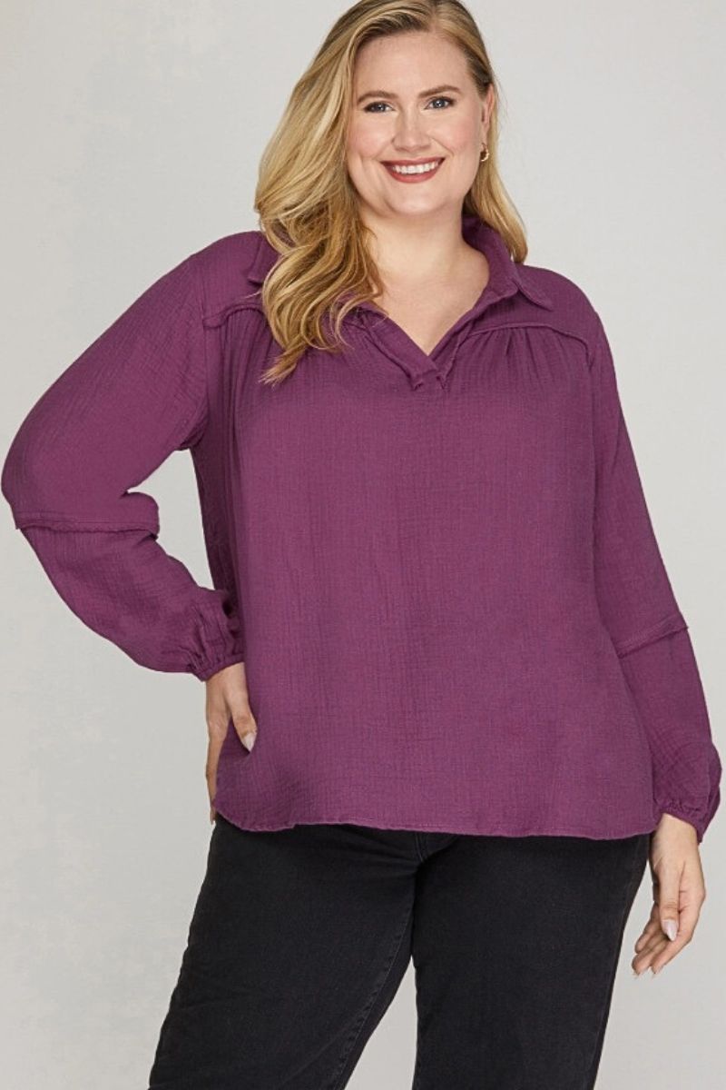 Woman wearing a purple blouse with a plain background
