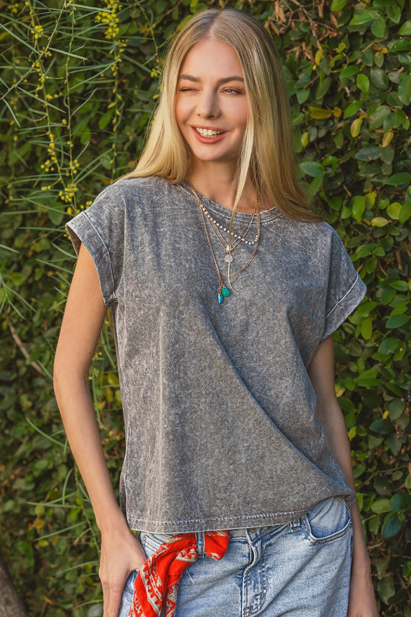 Woman wearing an ash black washed t-shirt on a white background