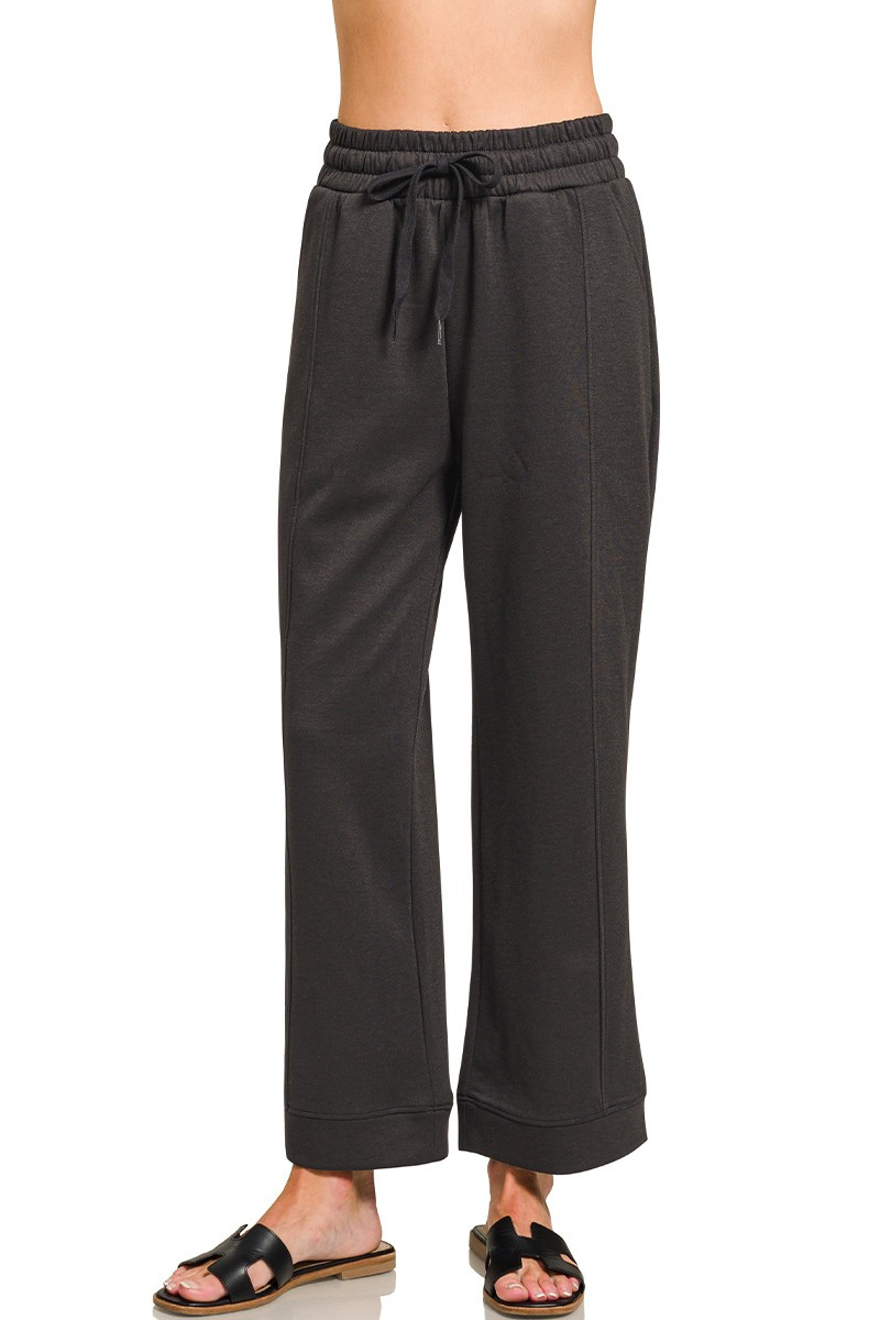 Black wide-leg pants with a drawstring waist on a white background