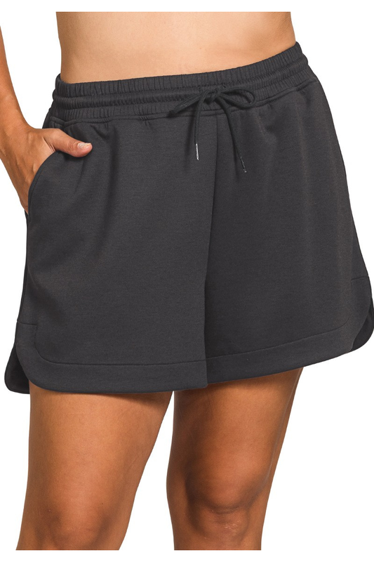 Black shorts worn by a person on a white background