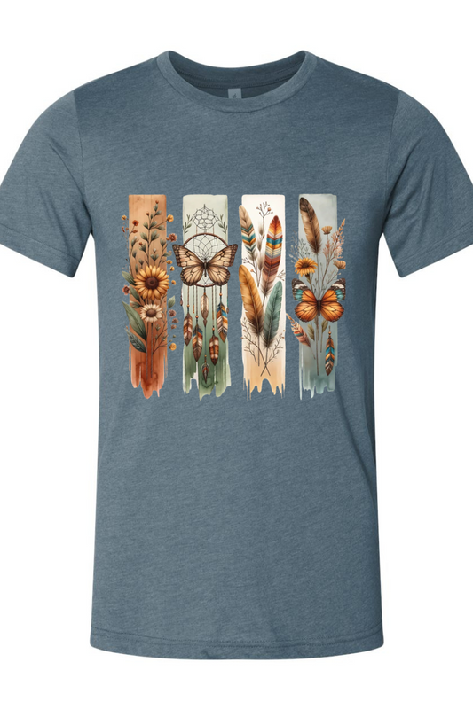 Blue t-shirt with nature-themed design featuring feathers, flowers, and a butterfly on a white background.