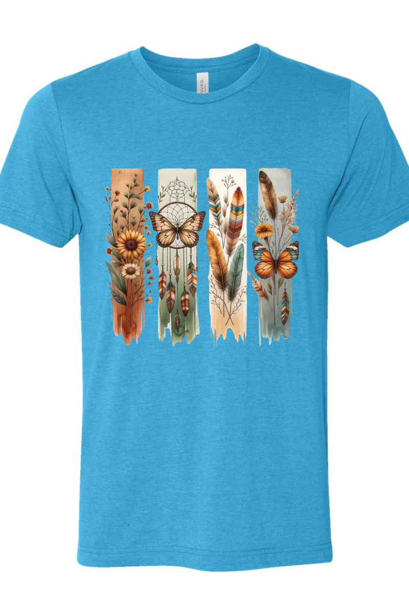 Blue t-shirt with a colorful design featuring feathers, flowers, and butterflies on a white background.