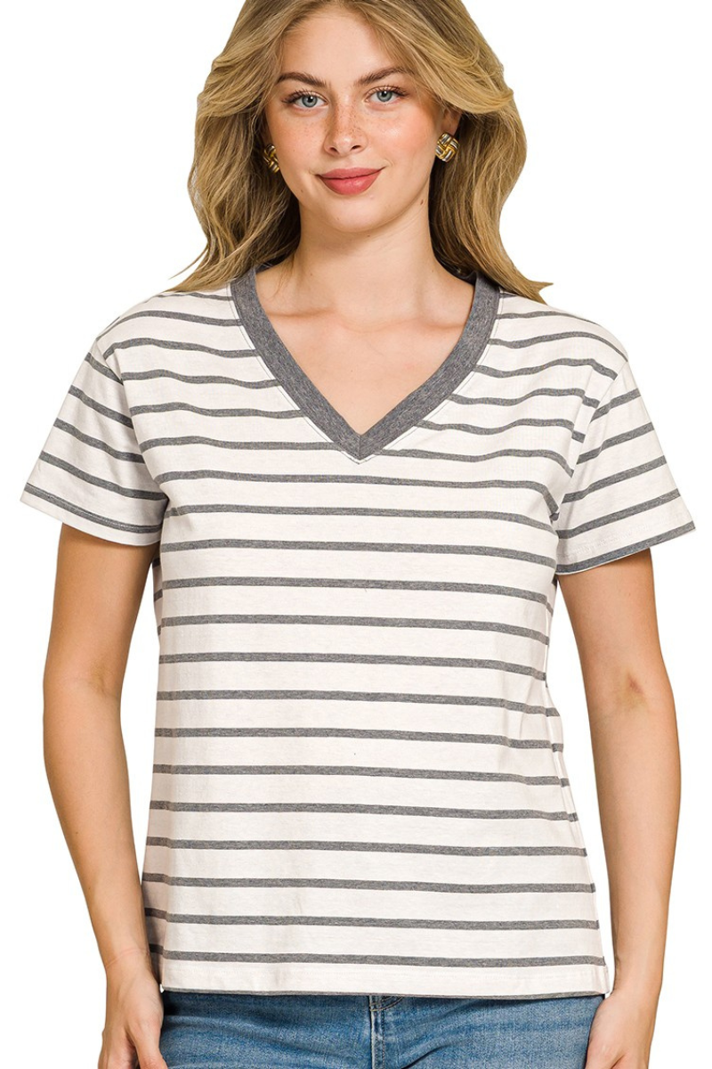Woman wearing a striped t-shirt with a plain background