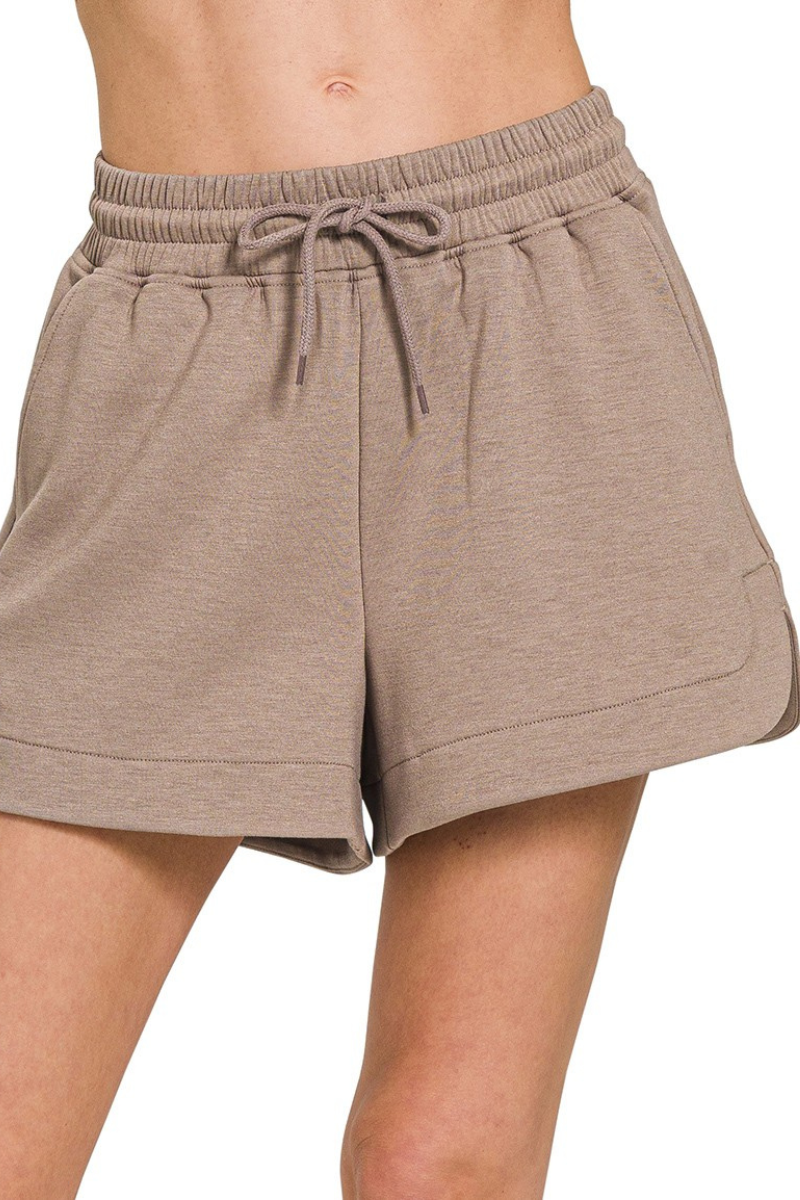 Brown shorts with a drawstring on a white background