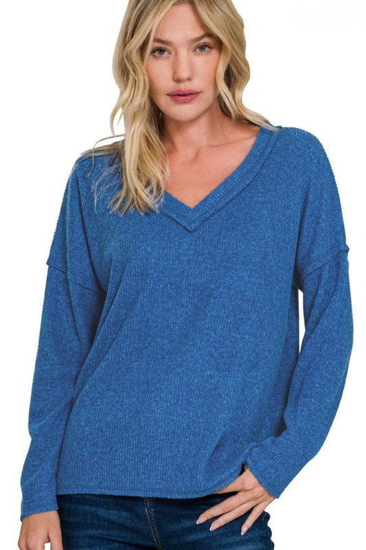Woman wearing a blue sweater on a white background