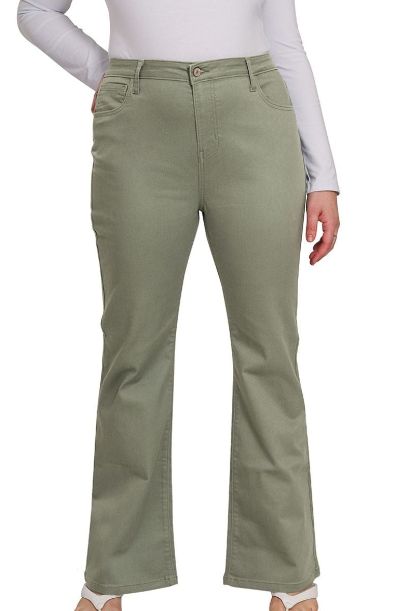 Green pants worn by a person on a white background