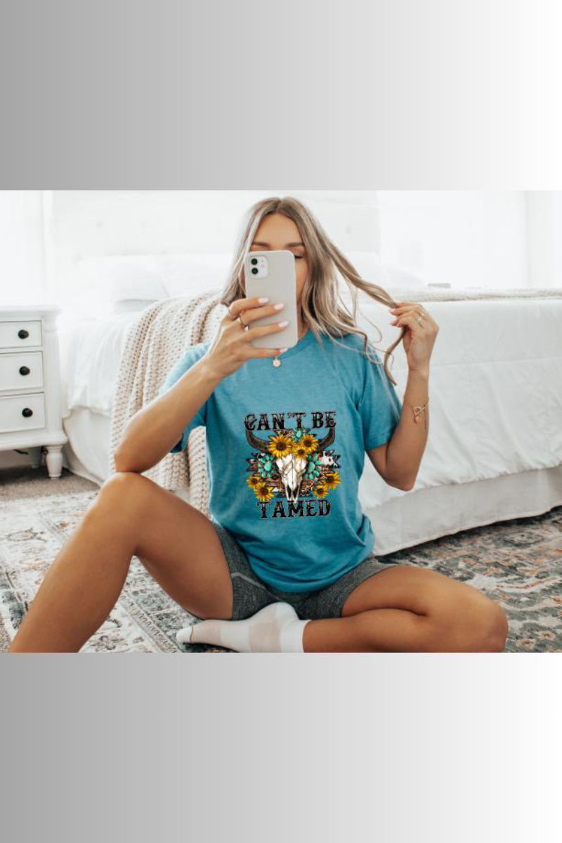 Eco-friendly Bella + Canvas unisex tee with Western design and the caption "Can't Be Tamed"