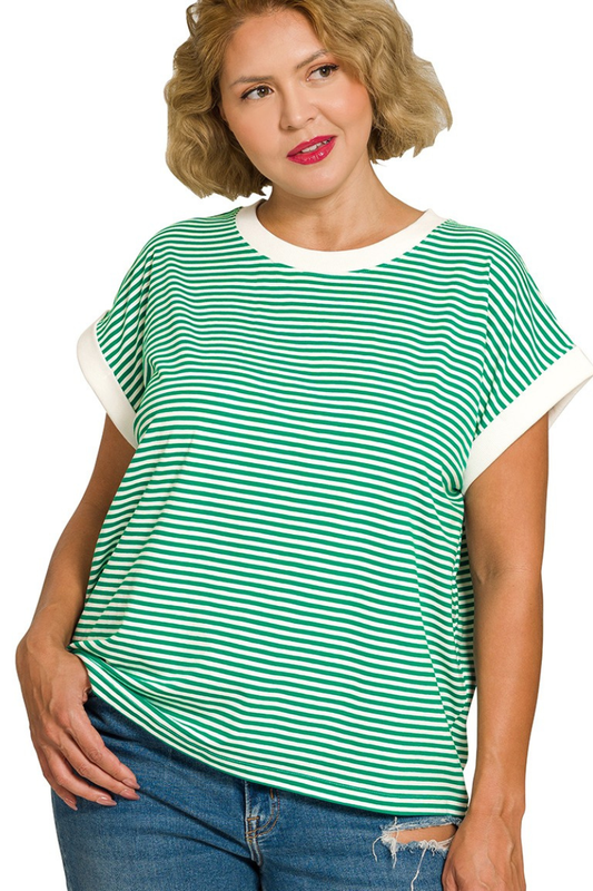 Woman wearing a green and white striped shirt with blue jeans on a white background