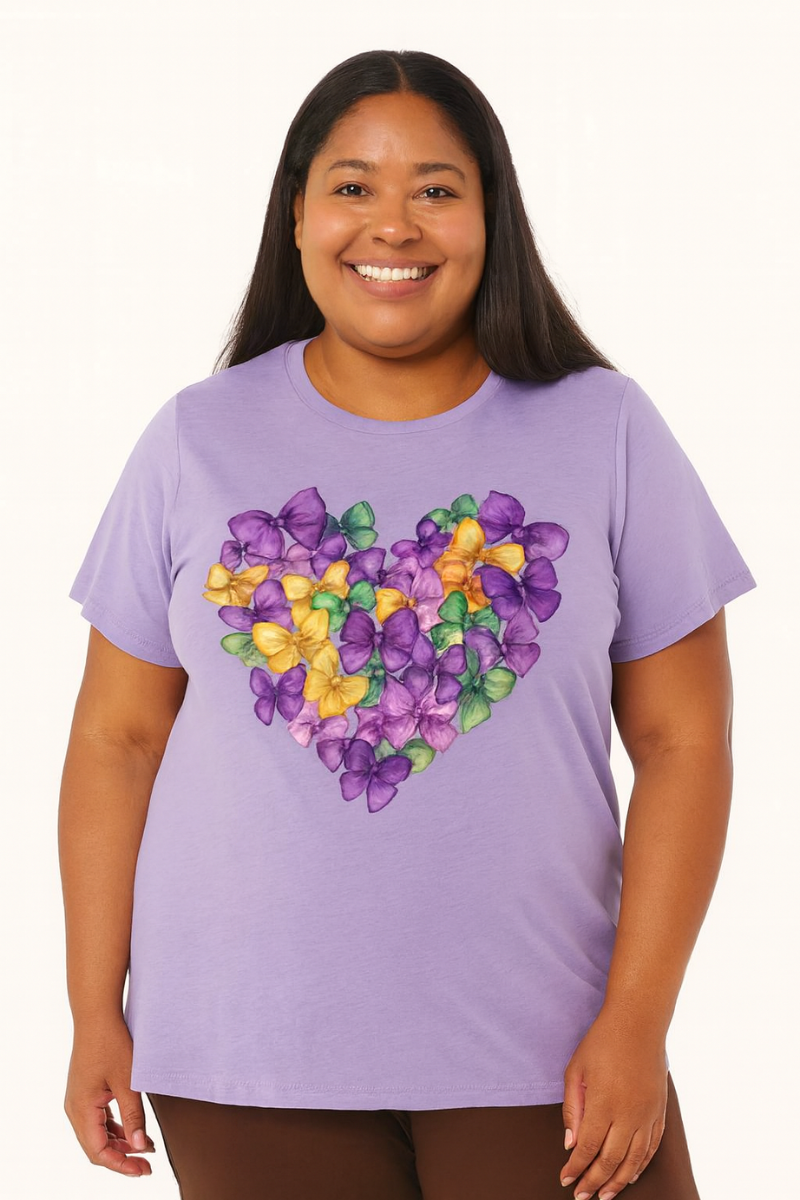 Person wearing a purple t-shirt with a colorful heart design on a white background