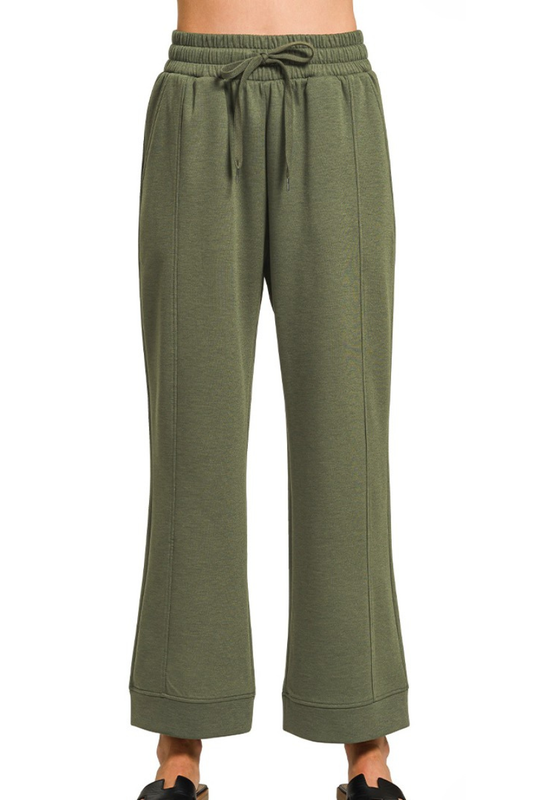 Green sweatpants with a drawstring on a white background