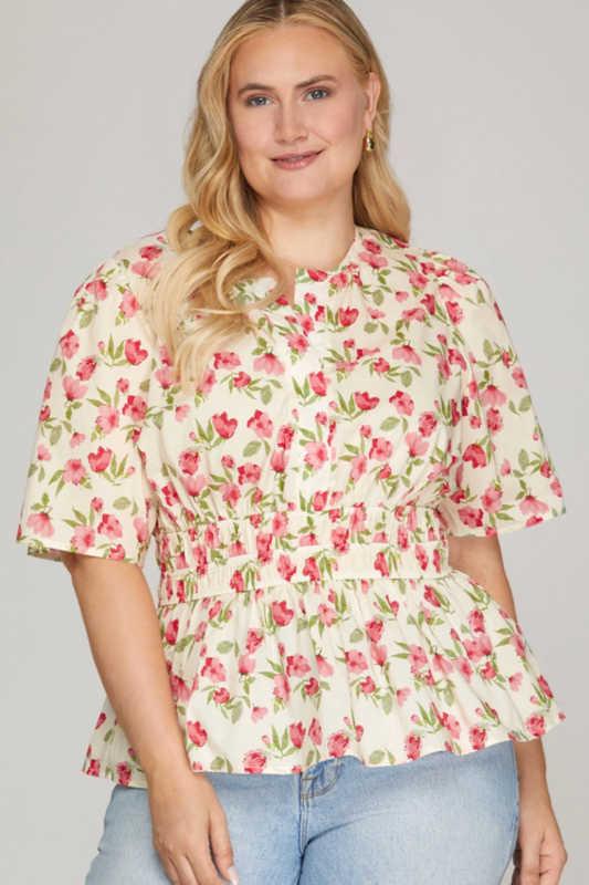 Woman wearing a floral blouse with a plain background
