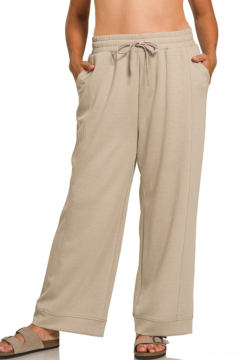 Beige wide-leg pants worn by a person on a white background