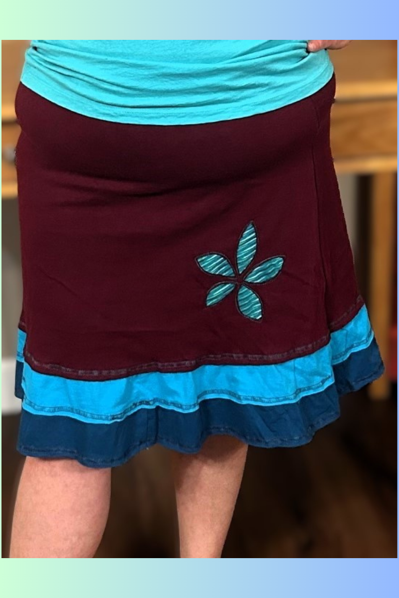 A flirty handmade upcycled cotton three-layer applique skirt in maroon.