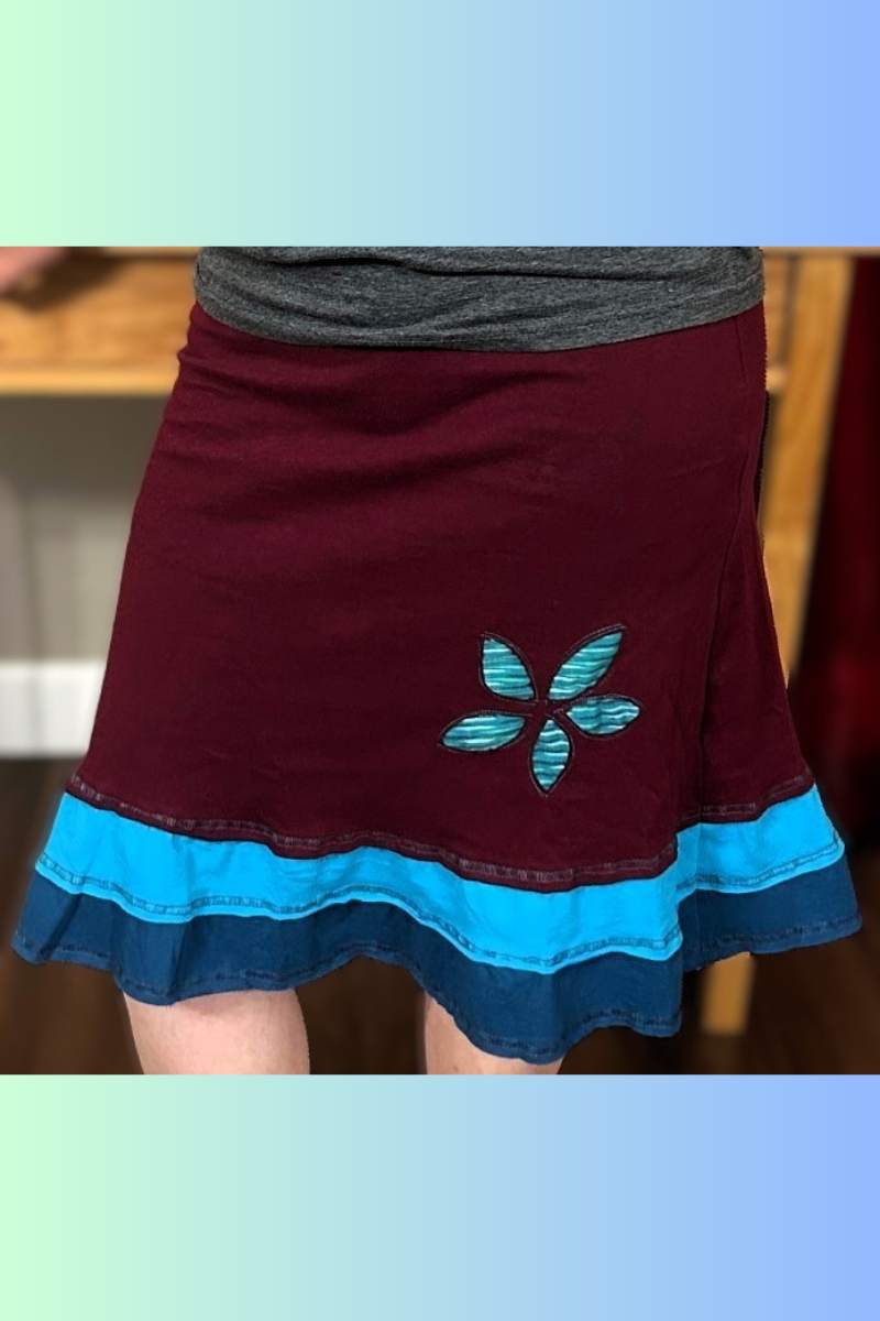 A flirty handmade upcycled cotton three-layer applique skirt in maroon.