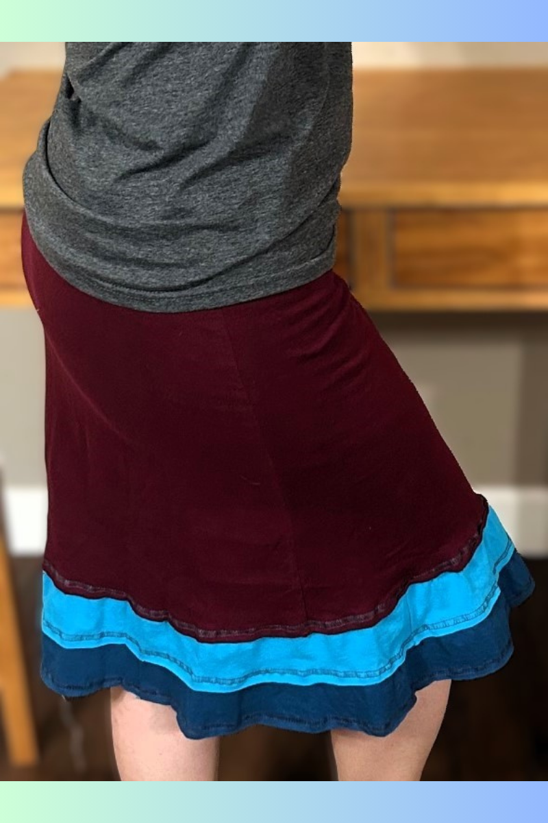 A flirty handmade upcycled cotton three-layer applique skirt in maroon.