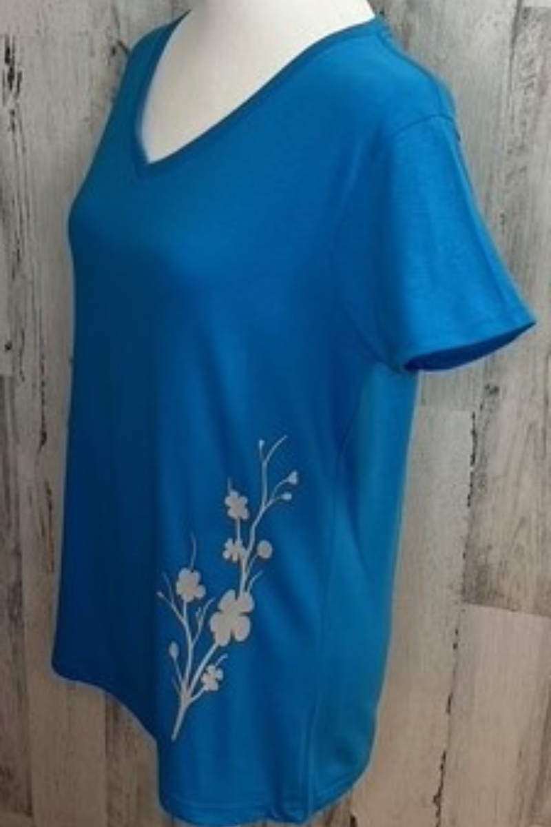 Gildan ladies v-neck tee in sapphire with cherry blossom silhouette printed with eco-friendly ink.